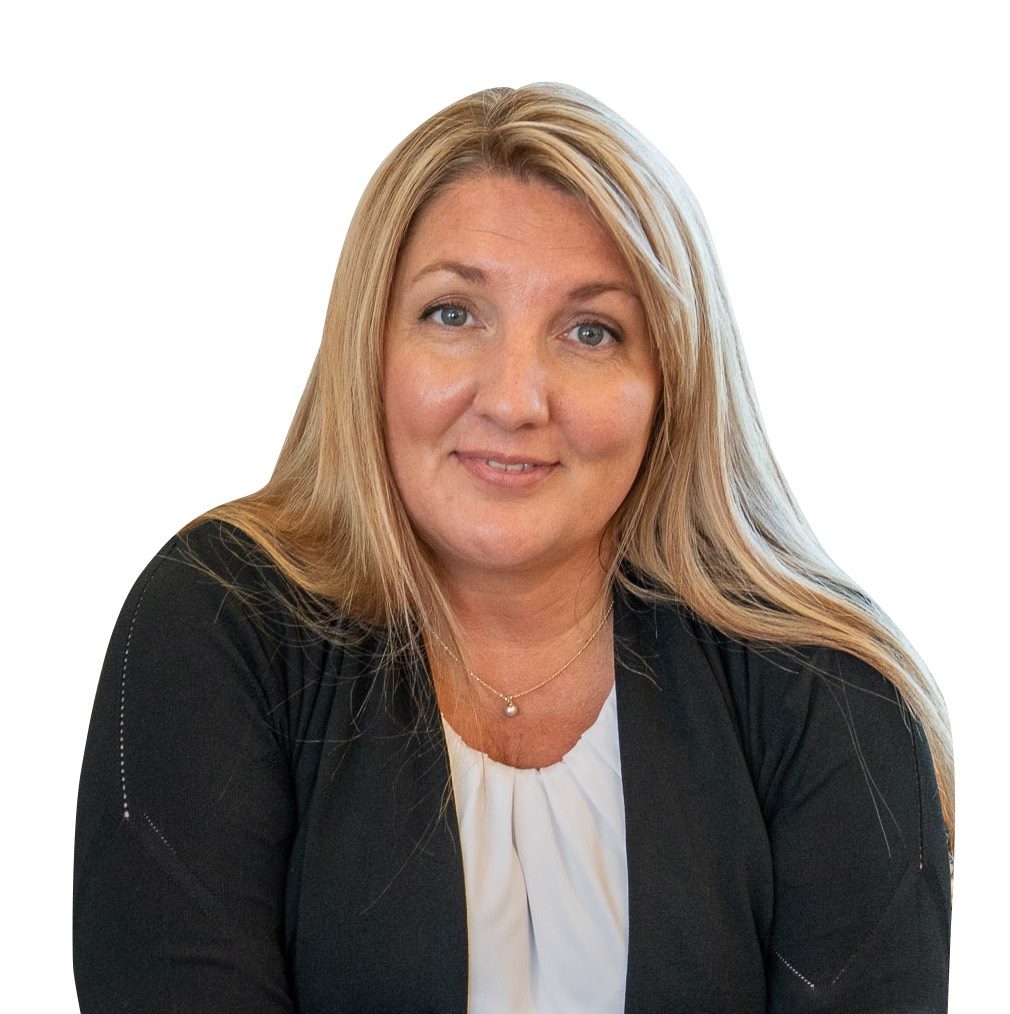 A smiling woman with long, straight blonde hair, wearing a black cardigan over a white blouse, sitting against a plain white background.